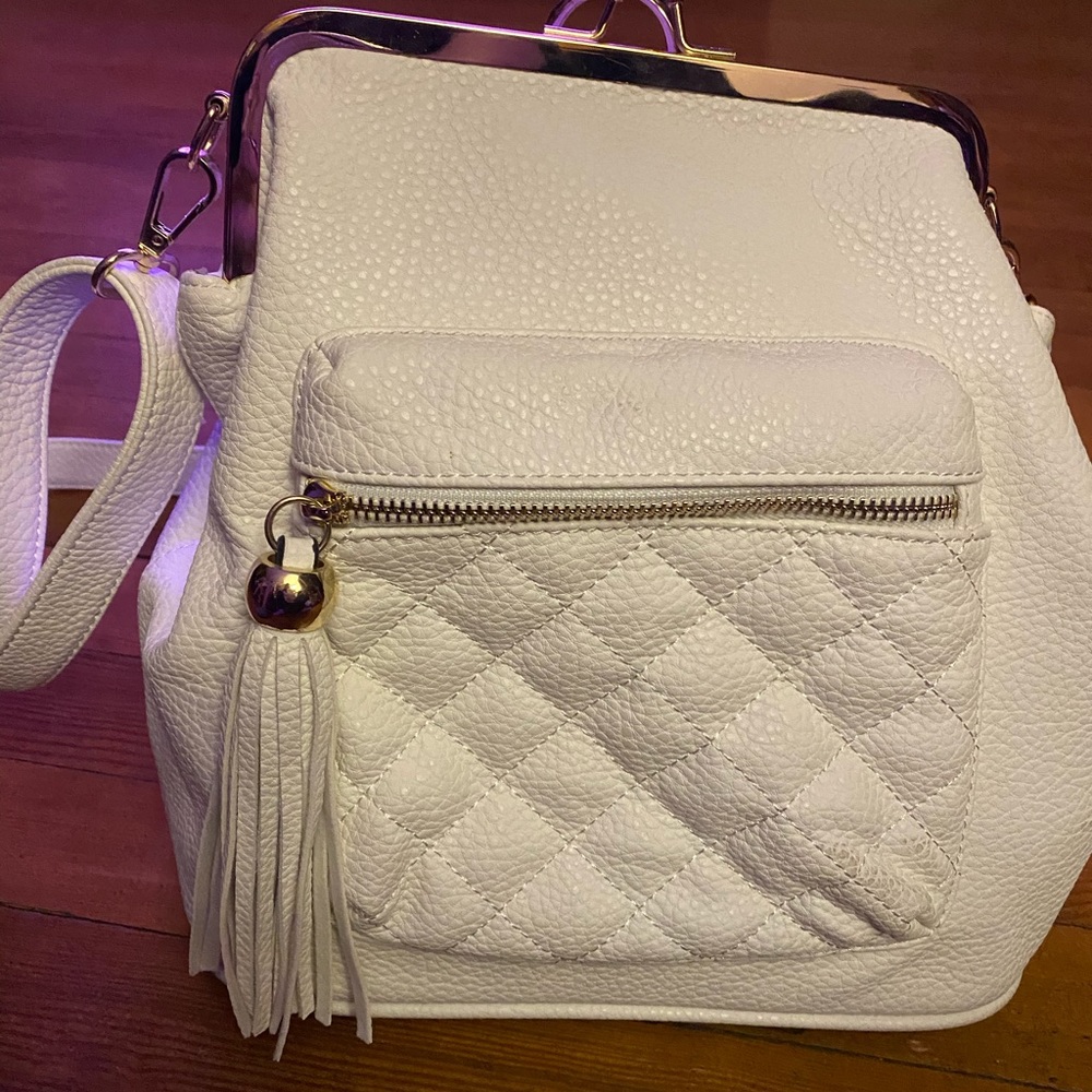 White three-way convertible bag.